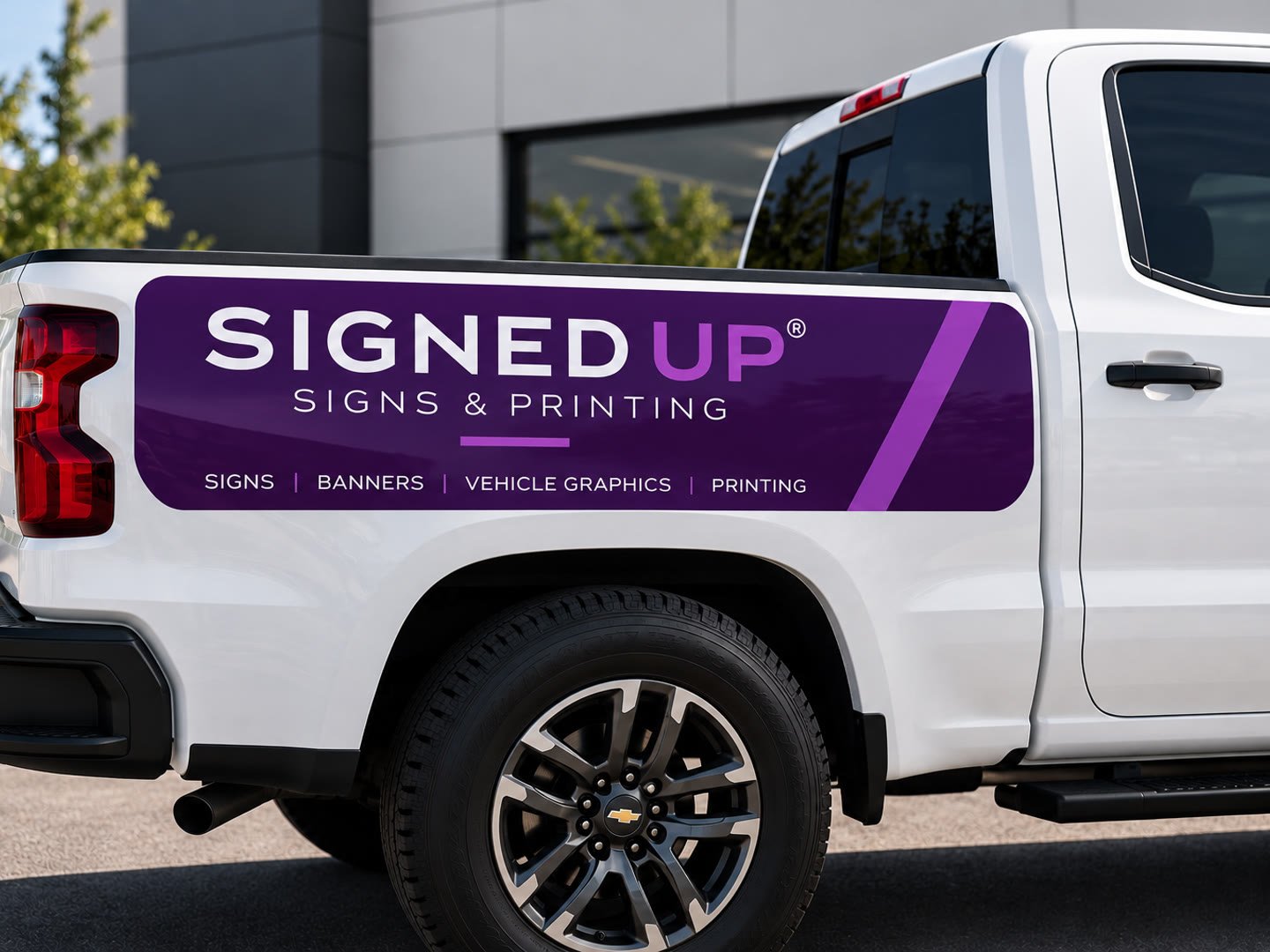 Purple Signed Up vinyl graphic panel on the bed side of a white pickup truck