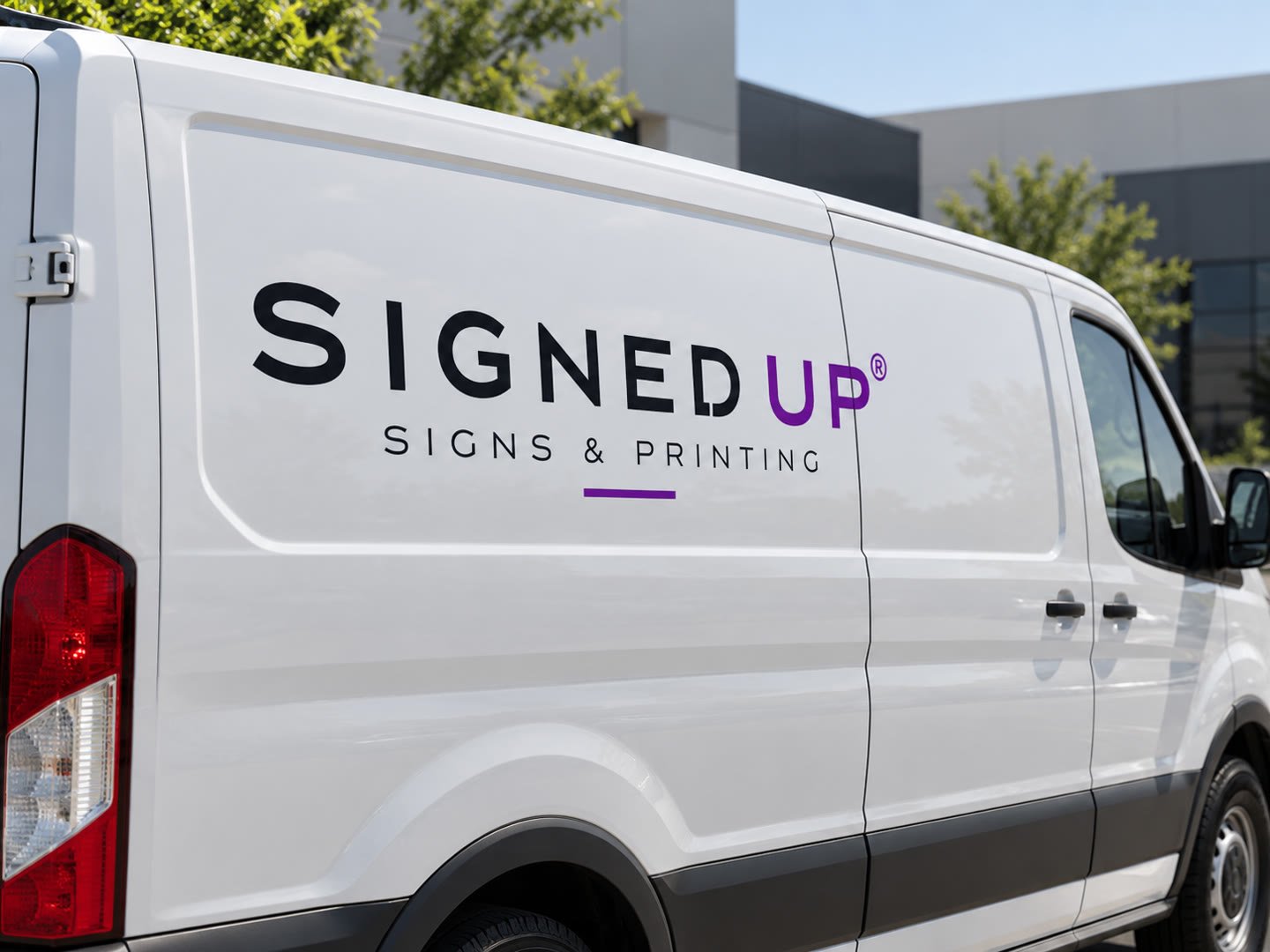Signed Up lettering cut to its own outline on the side of a white work van