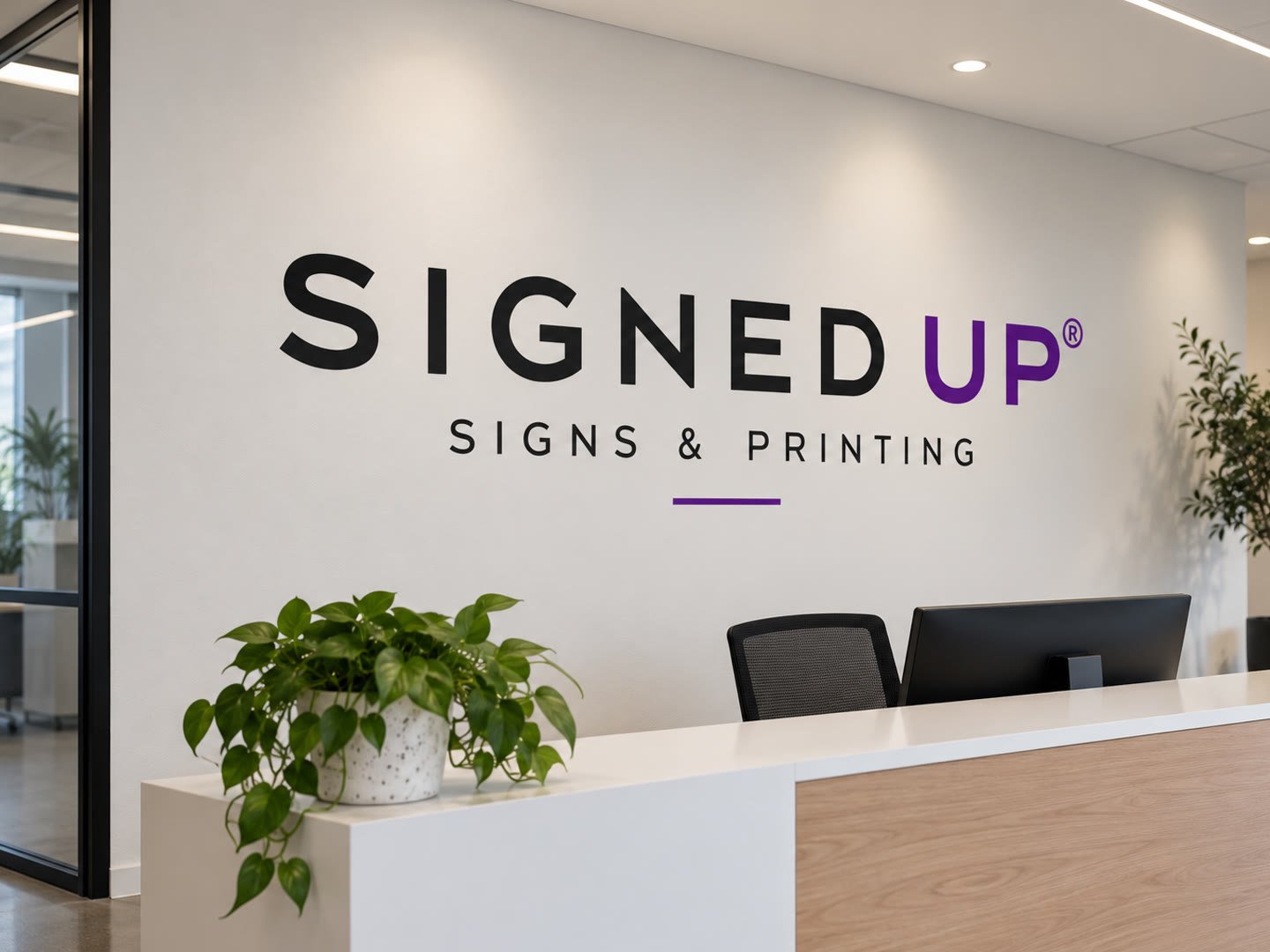 Signed Up lettering as a cut vinyl wall decal on a white reception wall behind the front desk