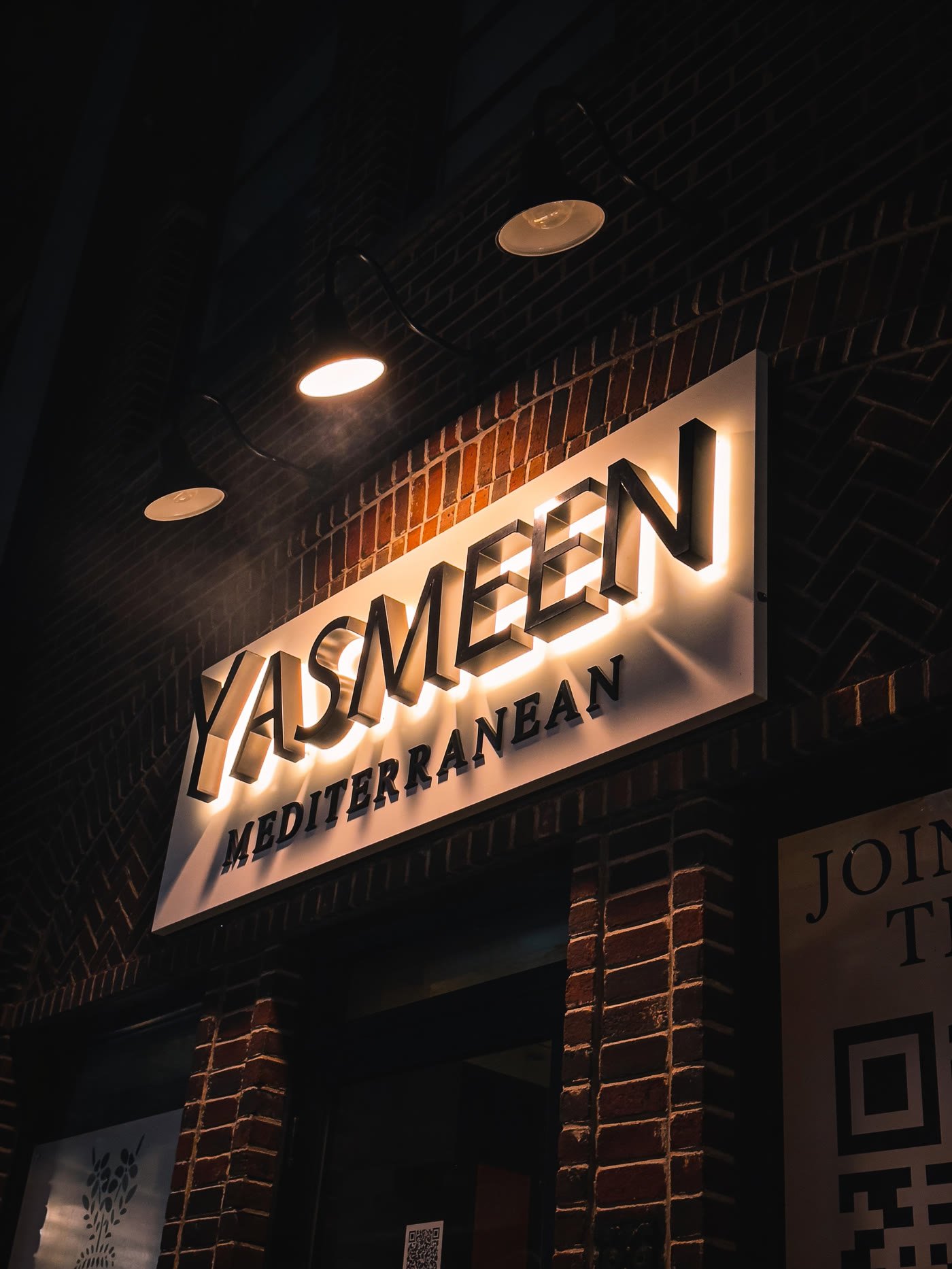 Backlit letters on a brick restaurant storefront